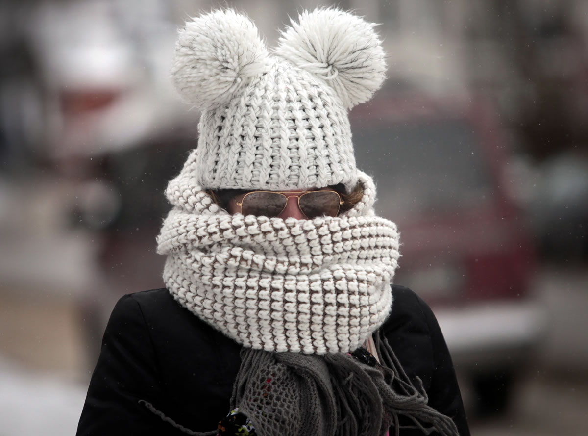JOHN HART/Associated Press
As frigid weather takes hold Friday, Kristy Gruley bundles up for a walk in Madison, Wis., where Monday's school is canceled.