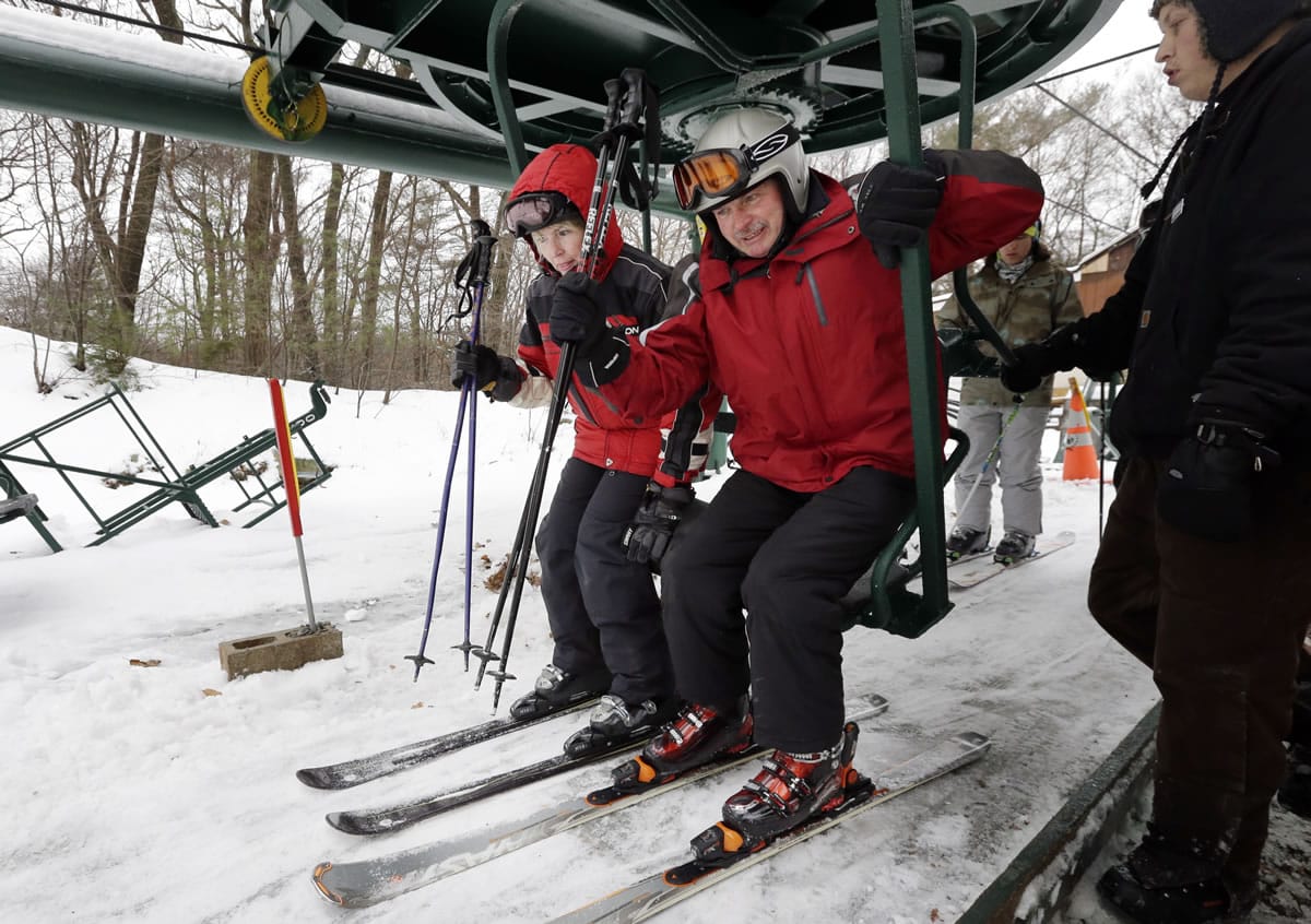 Skiers get on a chairlift at Blue Hills Ski Area.