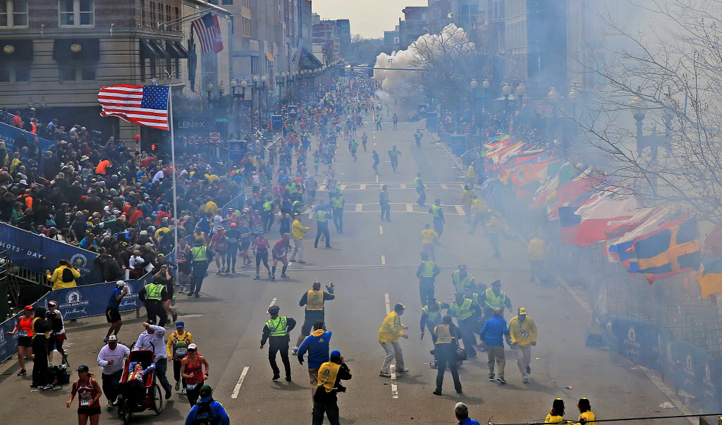 A plume of smoke rises from an explosion near the finish line of the 2013 Boston Marathon.