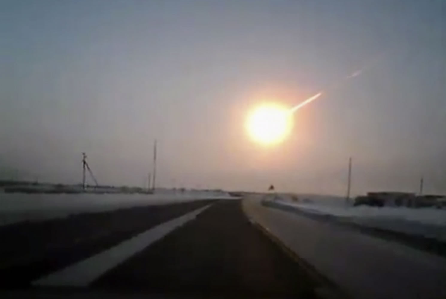 AP Photo/Nasha gazeta, www.ng.kz 
A dashboard camera in Russia caught this image of a magnitude -26 fireball in Chelyabinsk on Feb. 15. Research now shows that meteors about the size of the one in February -- and ones even larger and more dangerous -- are probably four to five times more likely to hit the planet than scientists believed before the fireball.