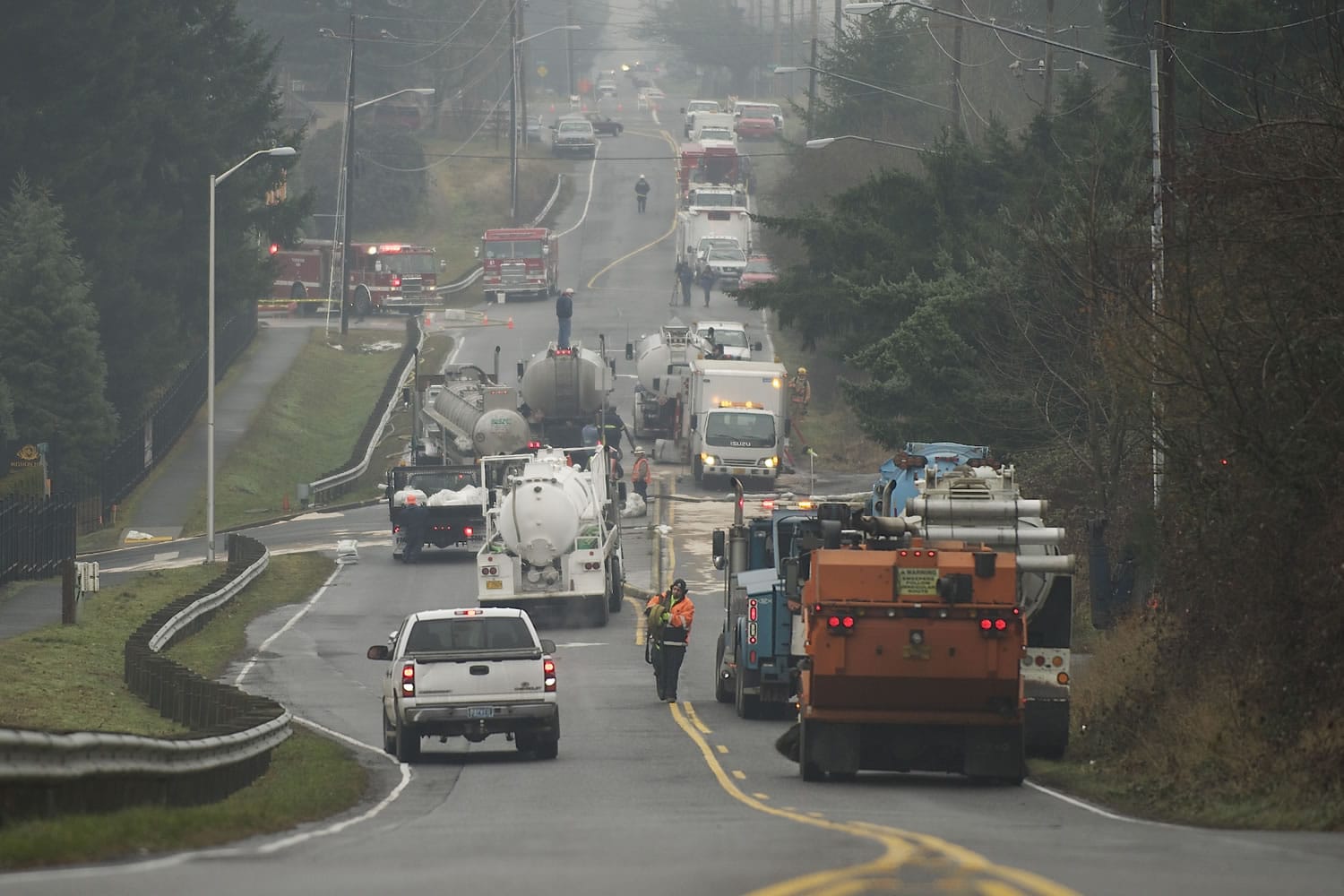 Emergency crews work to clean up a tanker truck accident on Northeast 18th street Friday in Vancouver.