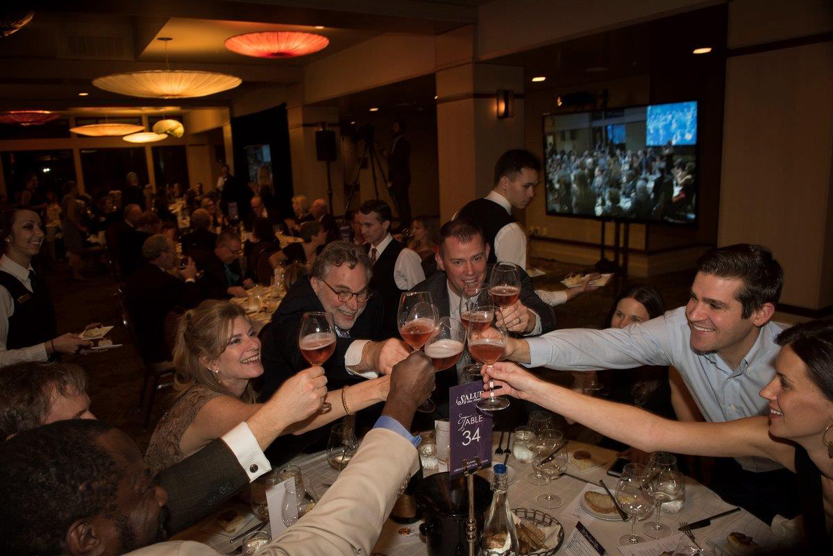 Mark and Vickianne Vlossak of St. Innocent Winery celebrate with guests at the Saturday Dinner and Auction Gala.