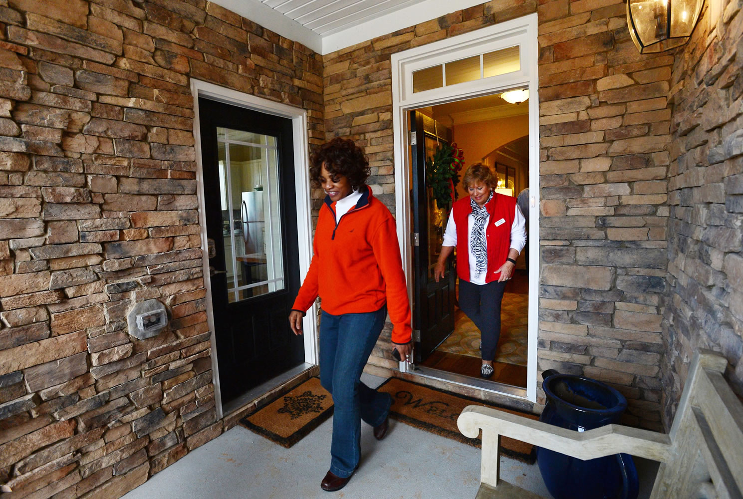 Elaine Adams and Lennar Homes representative Elaine Bridges exit the main entrance to a new &quot;Next Gen&quot; home in Apex, N.C., on Dec. 8.