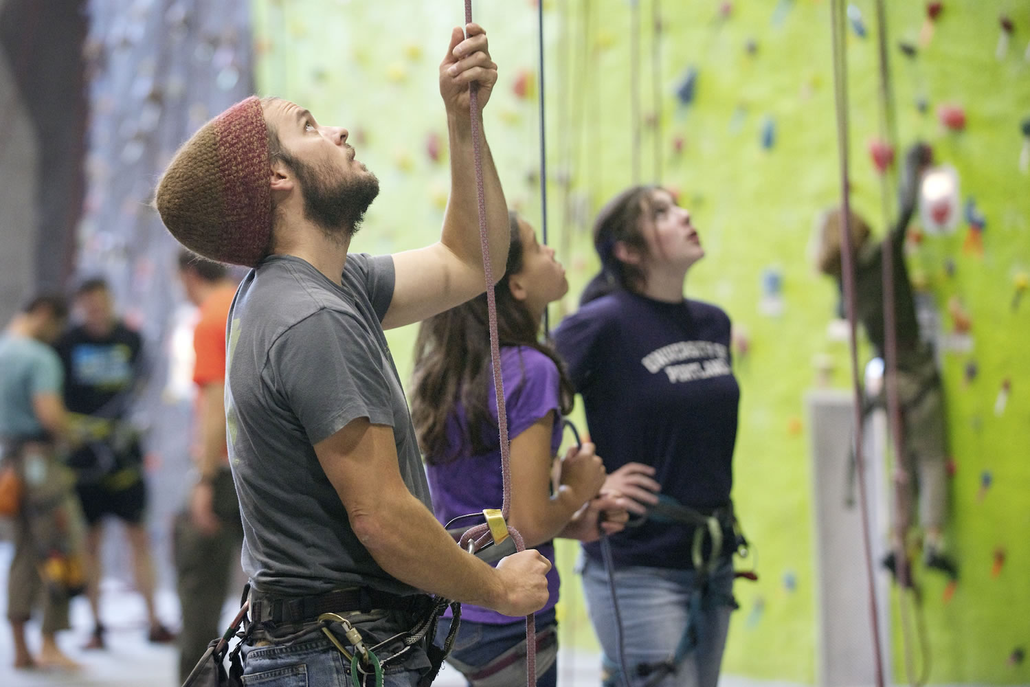 Bryan Caldwell, a climbing instructor at The Source Climbing Center, belays as a student climbs a wall during a class in October.
