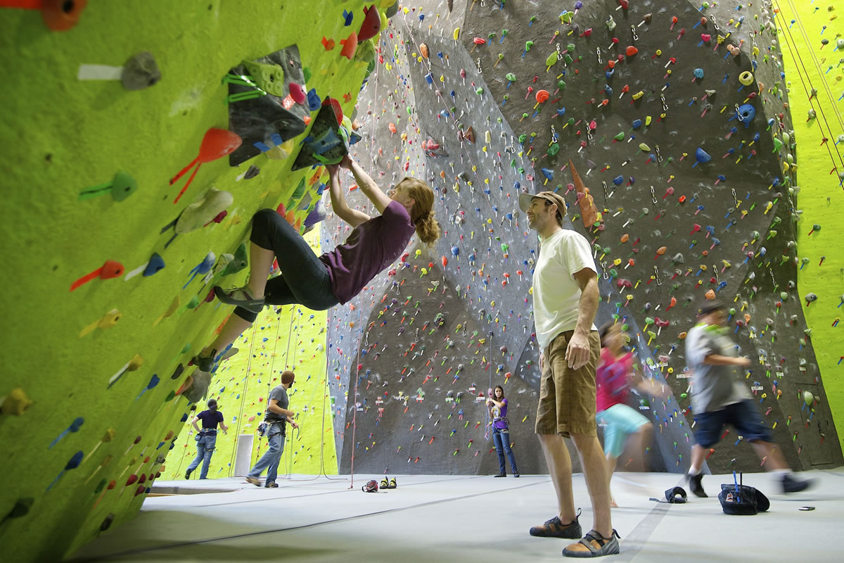 Jeff Balderree of Portland helps Kelli Kappler of Vancouver solve a &quot;problem&quot; on a climbing wall at The Source Climbing Center in downtown Vancouver.