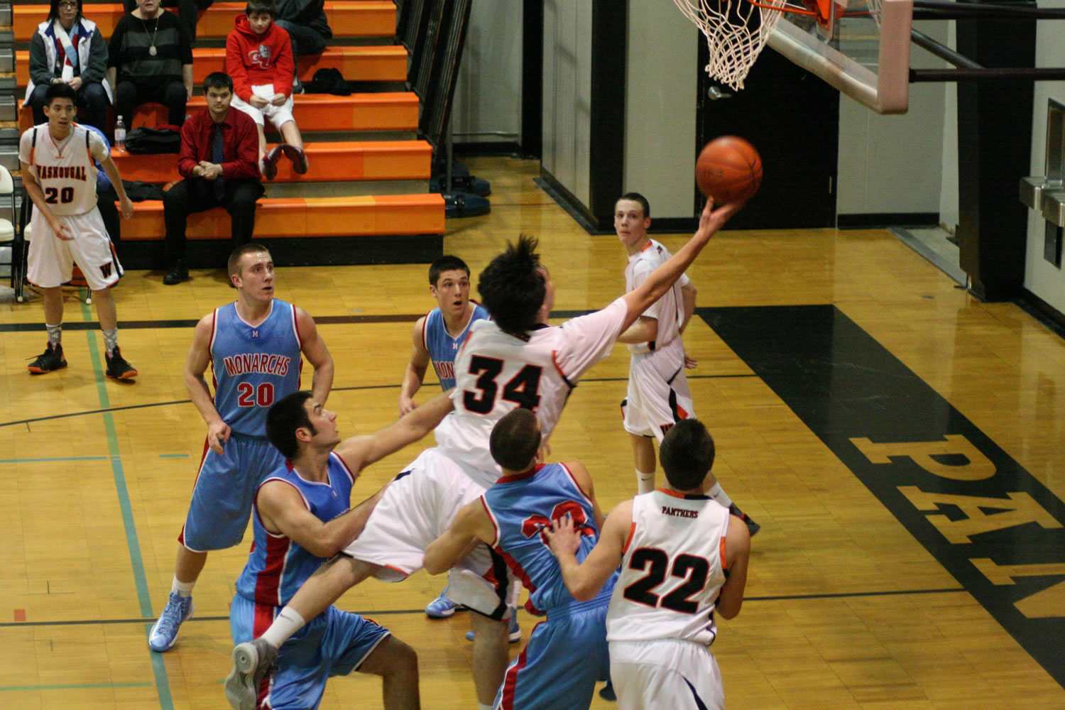 Washougal High School senior Aaron Deister splits the defense and scores a basket Thursday, at WHS. The Panthers defeated the Monarchs 66-58.