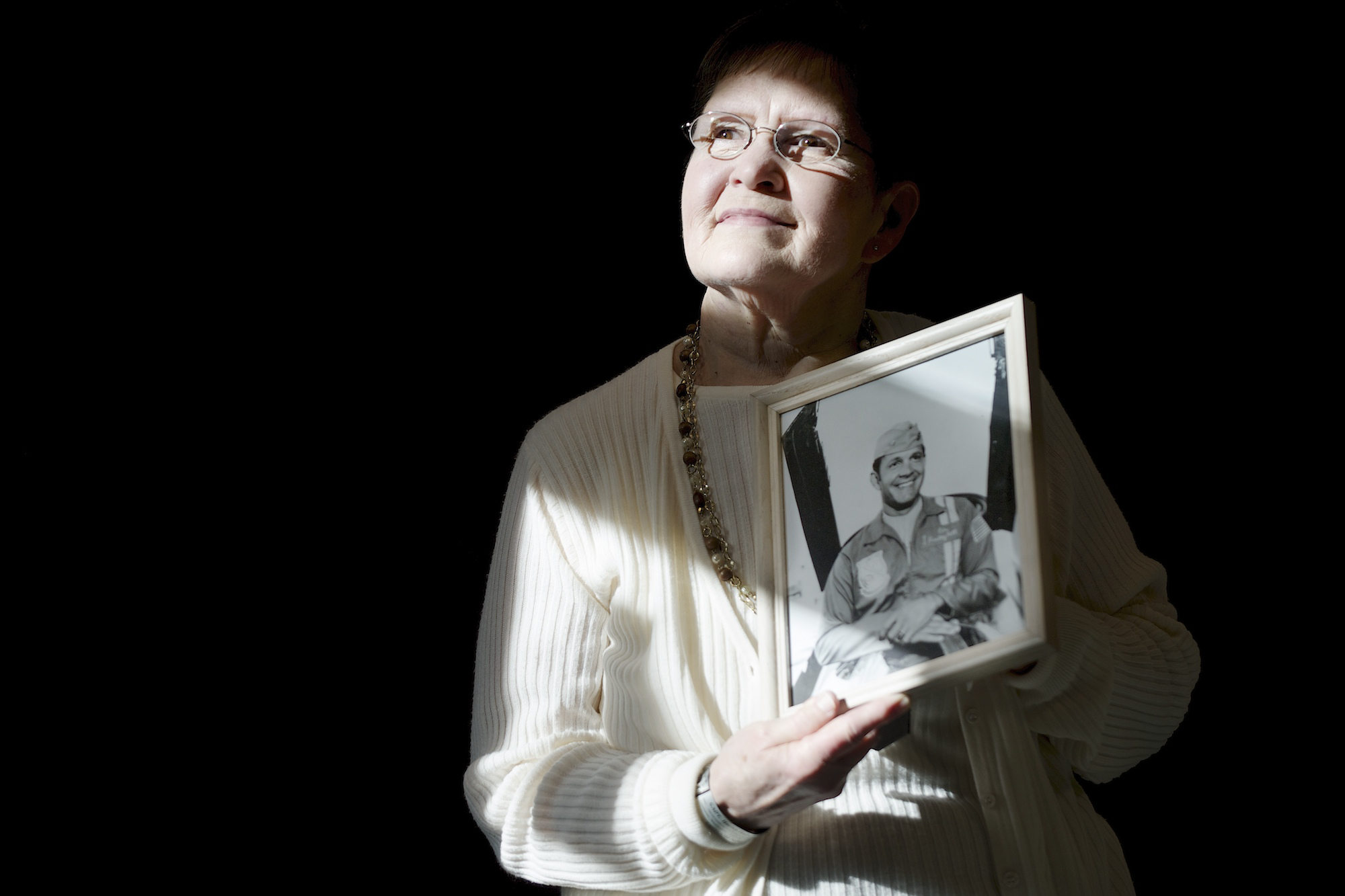 Gwen Hall Davis, the sister of missing Vancouver fighter pilot Harley Hall, holds a portrait of her brother.