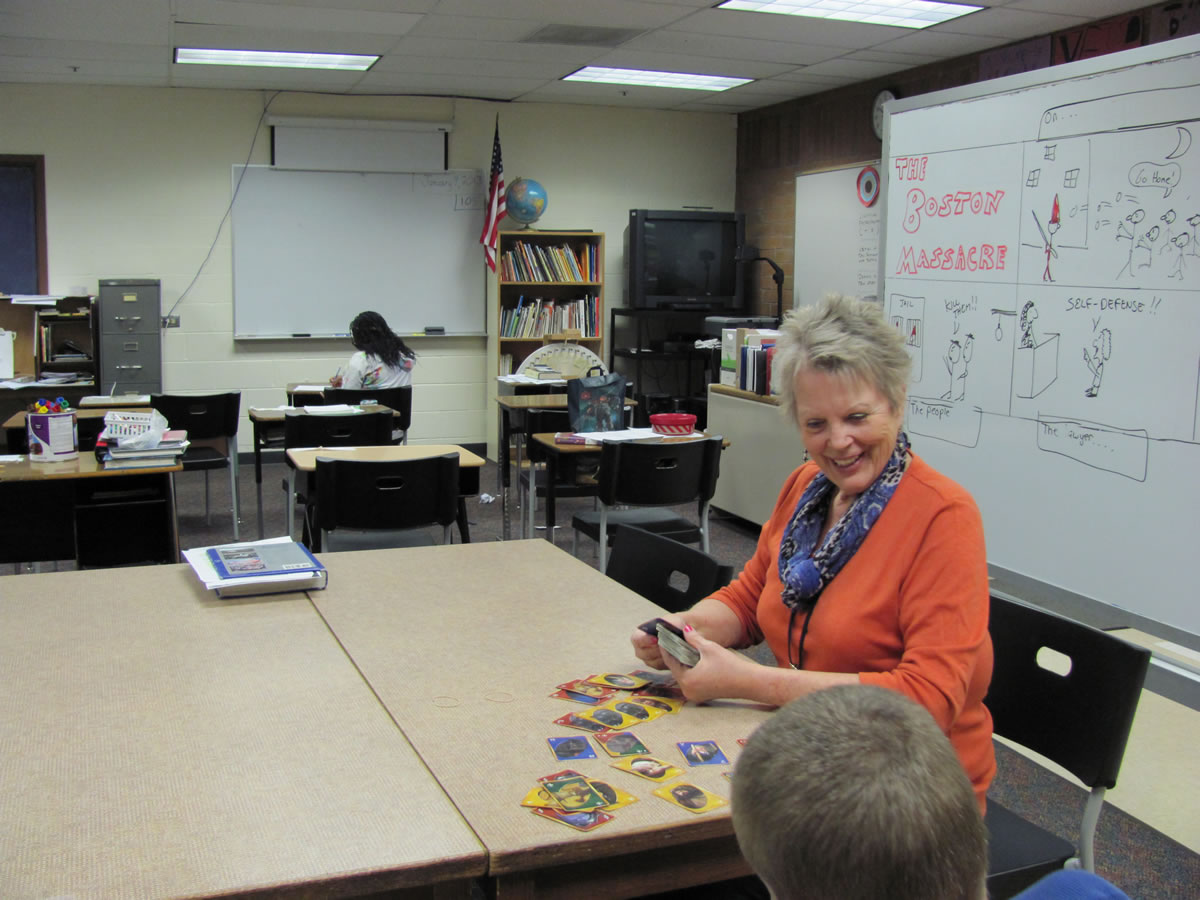 Linda Peters, a special education paraprofessional, assists an adaptive skills student at Jemtegaard Middle School.