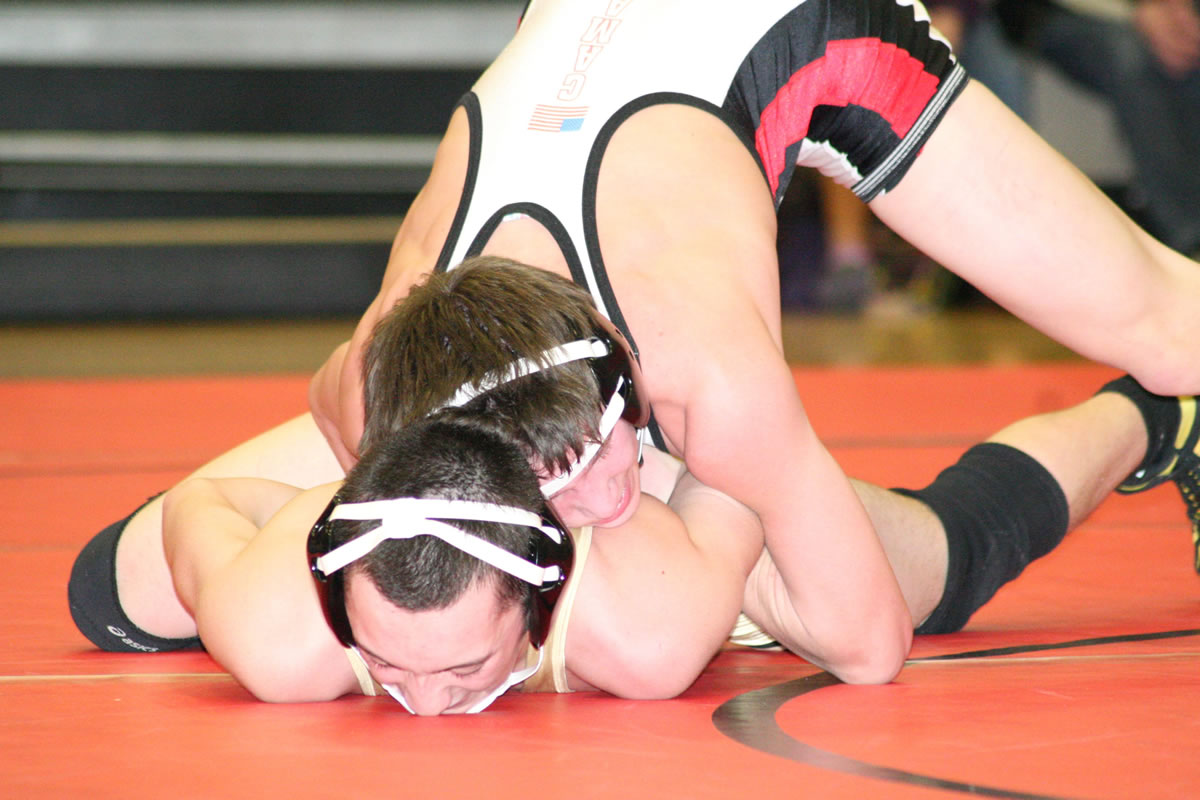Tye Lommasson locks the arms of Evergreen's Jordan Moore and grinds his face into the mat, at Camas High School.