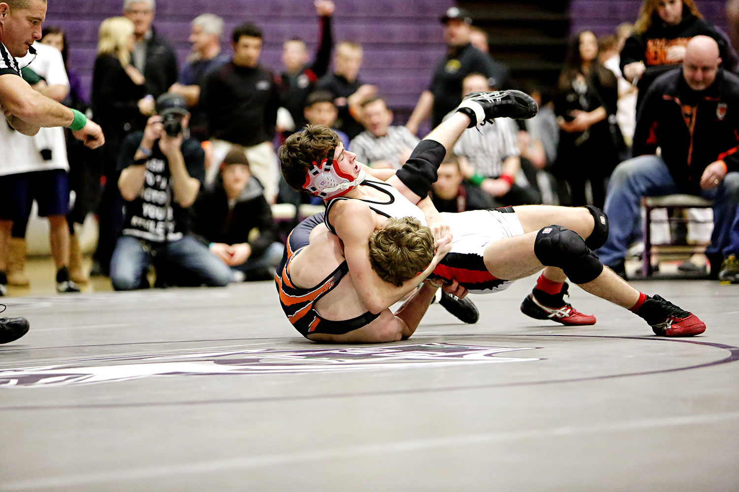 Camas' Austin Miller turns the tables on Battle Ground's Sean Trenda during the 132-pound 4A regional championship match Saturday, at Heritage High School.