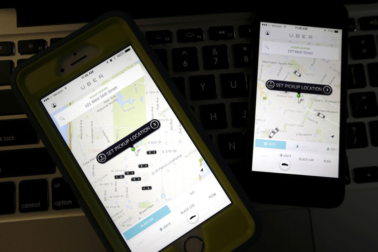 Smartphones display Uber car availability in New York.