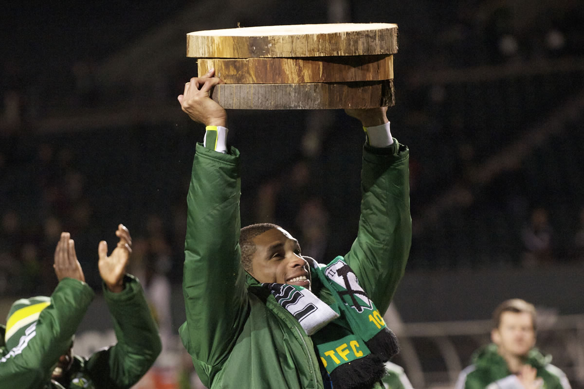 Portland Timbers forward Ryan Johnson hoists his three log cuttings, one for each goal he scored, after Sunday's 3-3 preseason tie against San Jose at Jeld-Wen Field.