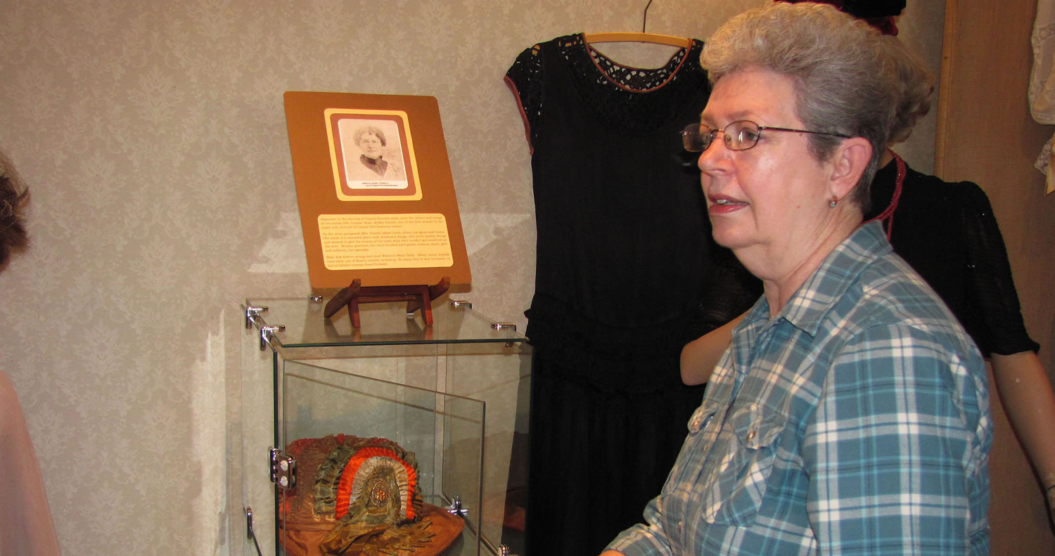 Volunteer Coordinator Lois Cobb points out a hat collection currently on display at the Two Rivers Heritage Museum.