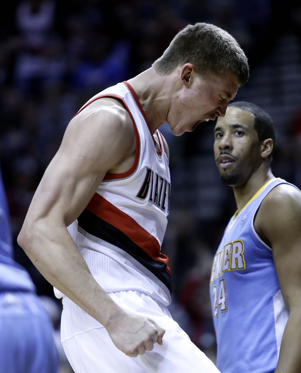 Portland's Meyers Leonard, left, reacts after scoring with Denver Nuggets guard Andre Miller looking on during the second half Wednesday.