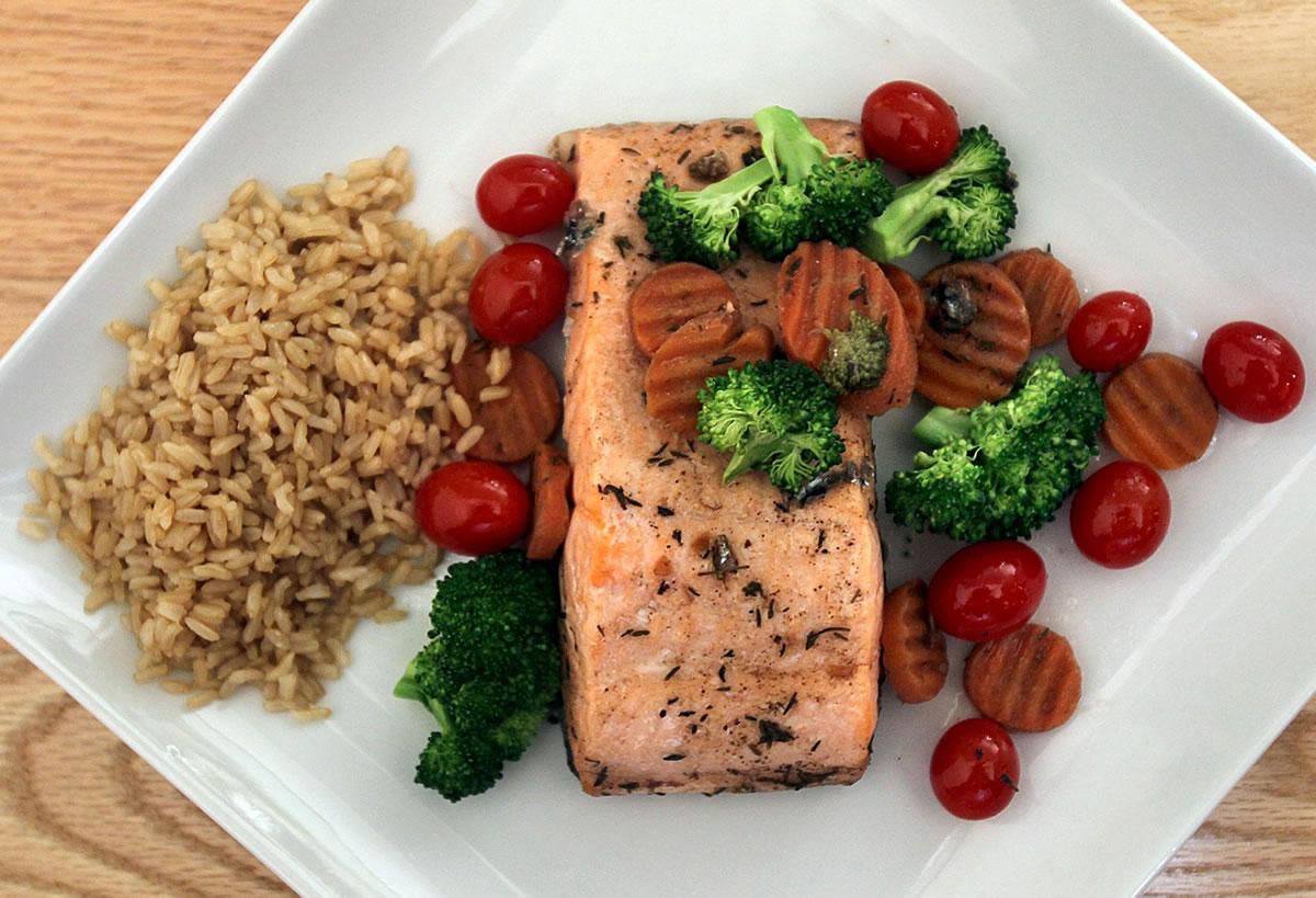 Wine-poached salmon served with vegetable medley makes for a quick meal.