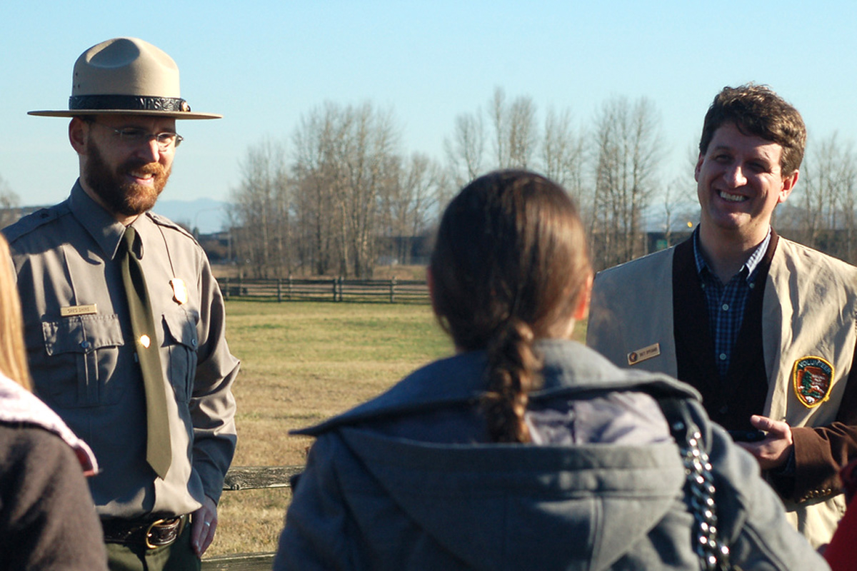 Brett Oppegaard, of Camas (right), gives a demonstration of the Fort Vancouver mobile app to a Washington State University Vancouver class. Chief Ranger Greg Shine is pictured on the left.