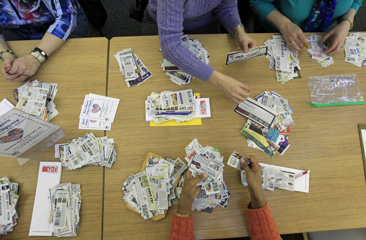 Members of the Savvy Savers Coupon Clippers gather twice a month to swap their unwanted coupons for ones they want/need at Southeast Regional Library in Garner, N.C.