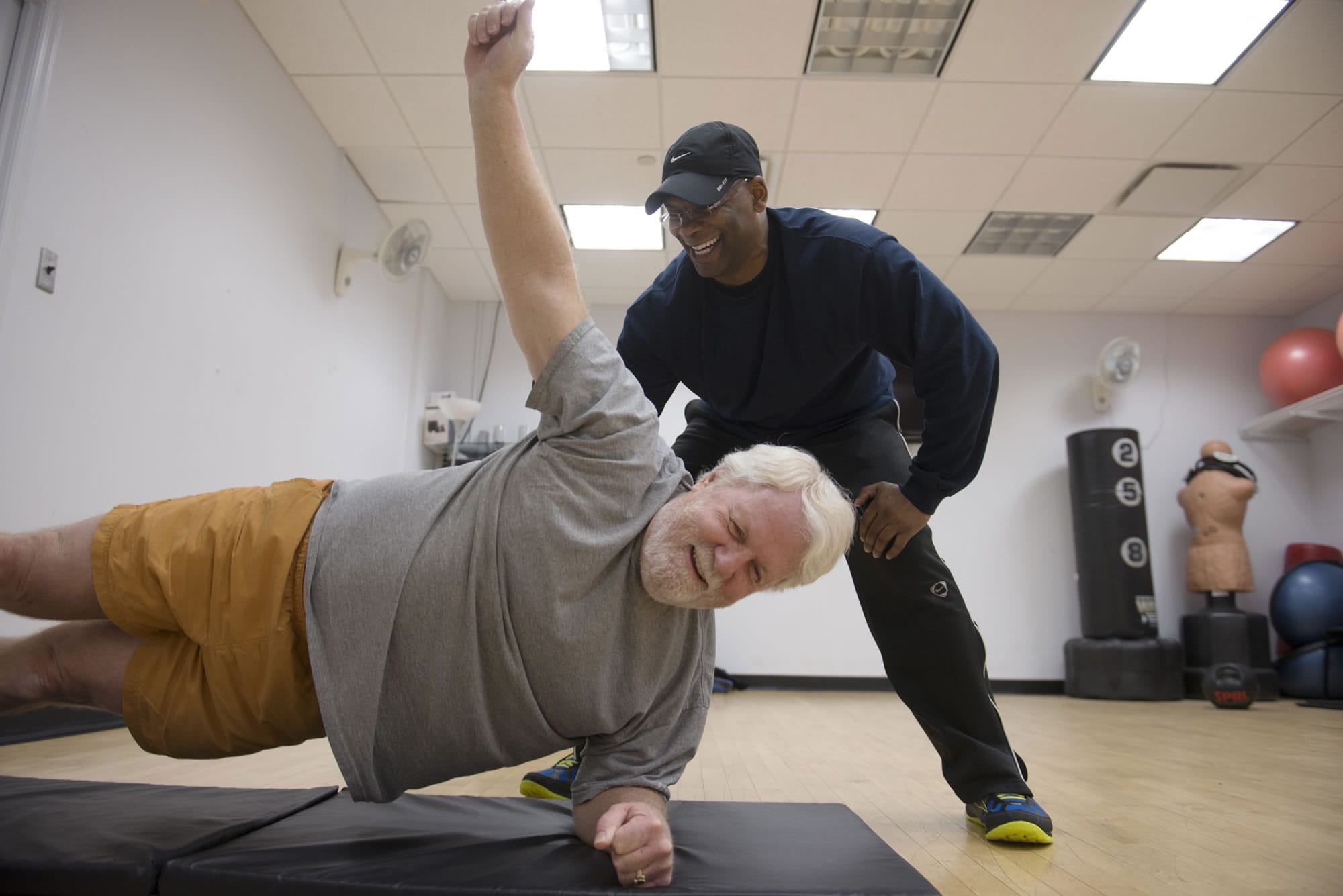 Bryant Johnson, standing, guides Greg Hughes, chief deputy of the D.C. District Court, through core training exercises on March 6 in Washington.