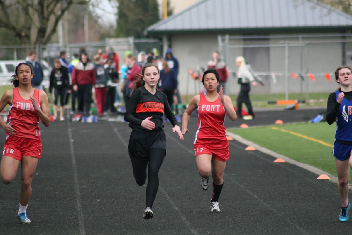 Kaitlyn Johnson (left) captured first place for Washougal in the 100, 200 and the triple jump Thursday, in Longview.