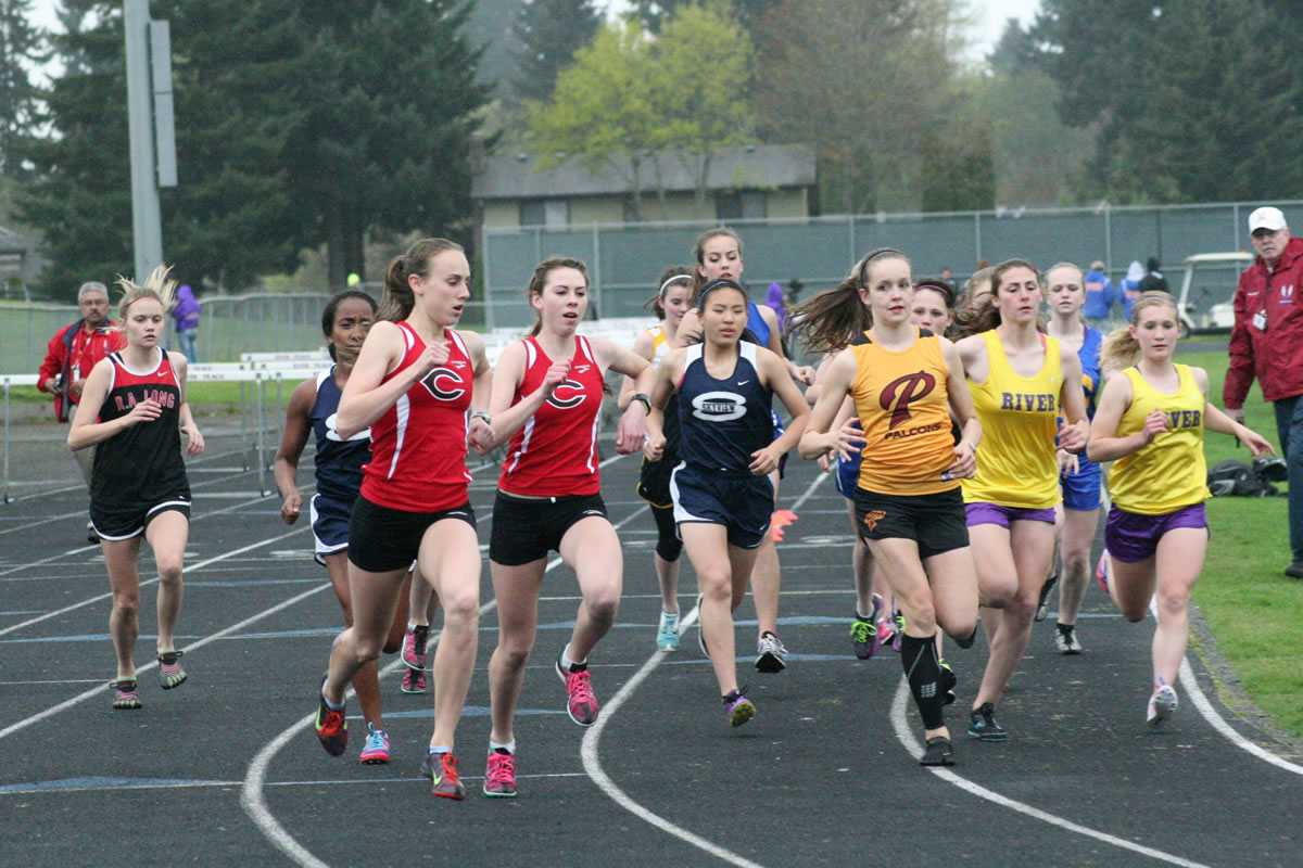 Camas runners Alexa Efraimson and Alissa Pudlitzke (left to right) stuck by each other in the 3,200-meter run during the John Ingram Twilight track and field meet Friday, at Columbia River High School. Pudlitzke won this race by setting a 16-second personal best time.