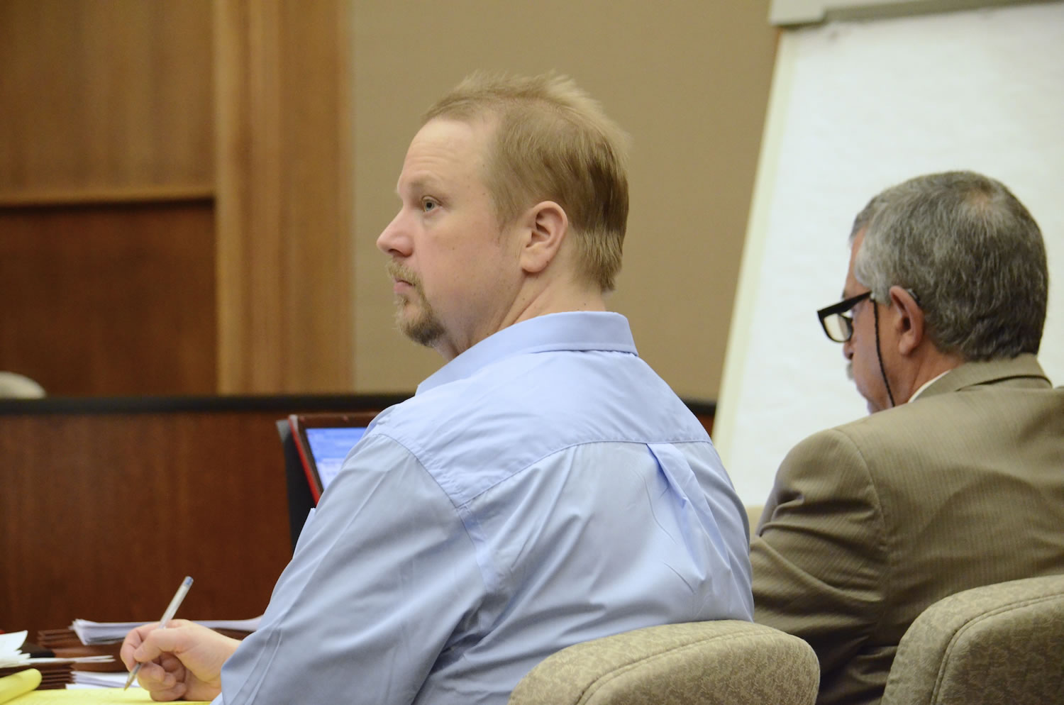 Troy Fisher, left, accused of killing his father, listens to testimony from a prosecution witness Tuesday in his trial in front of Clark County Superior Court Judge Barbara Johnson.