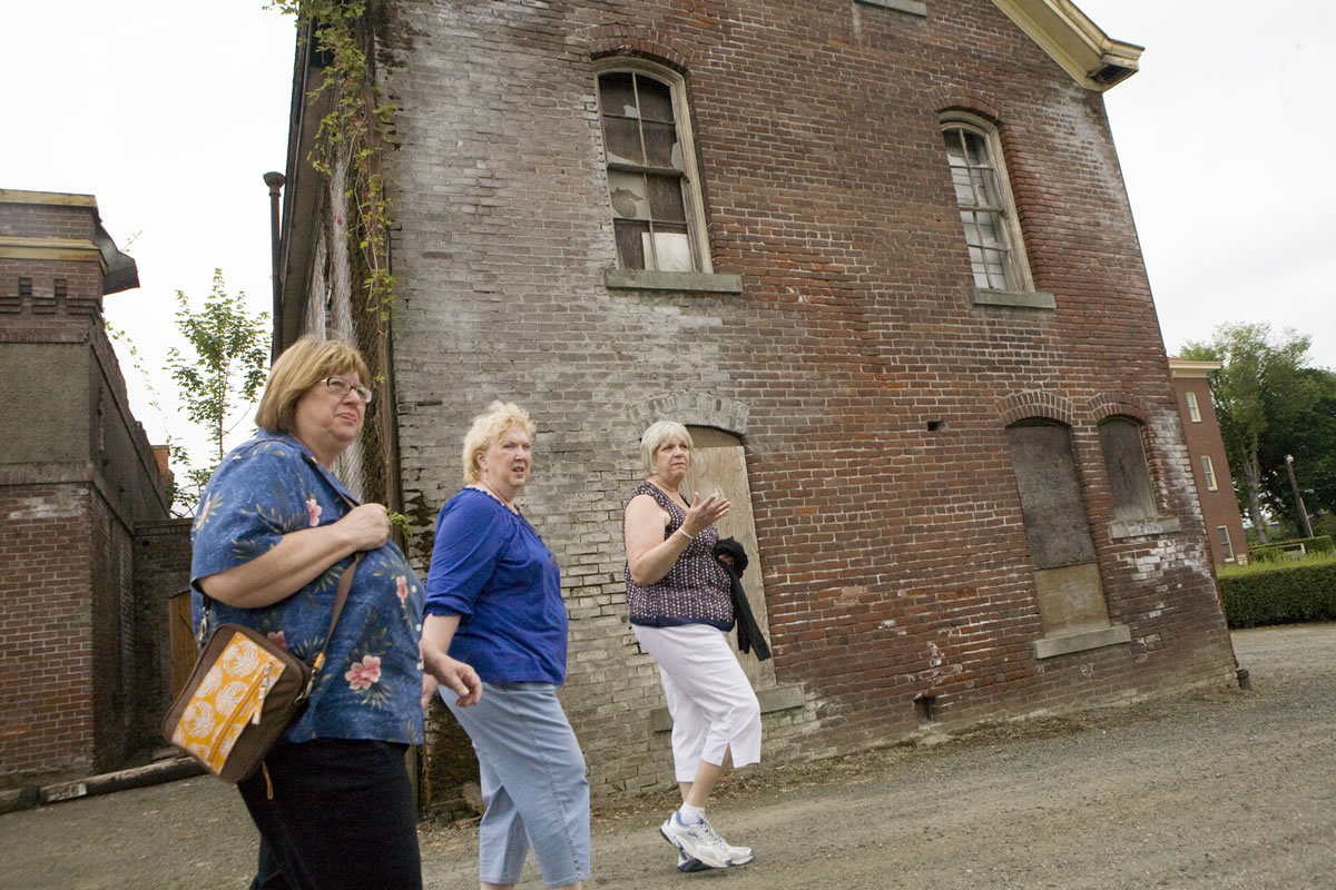 Kathleen Saxton, right, walks around the outside of the Academy with a few of her friends in July 2009 during the Clark County Historical Museum walking tour of Mother Joseph's Providence Academy.