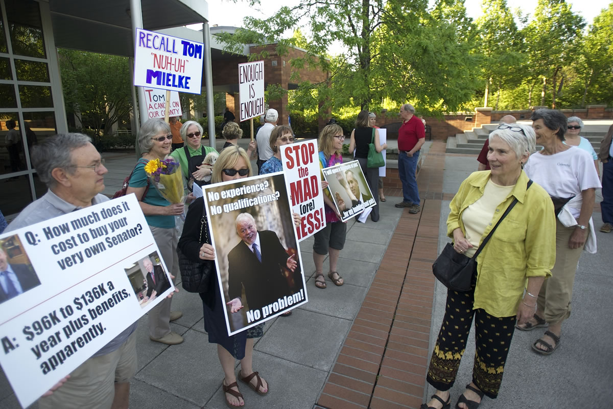 Protesters opposed to the hiring of State Sen. Don Benton stand outside the Clark County Public Services Center on Tuesday.