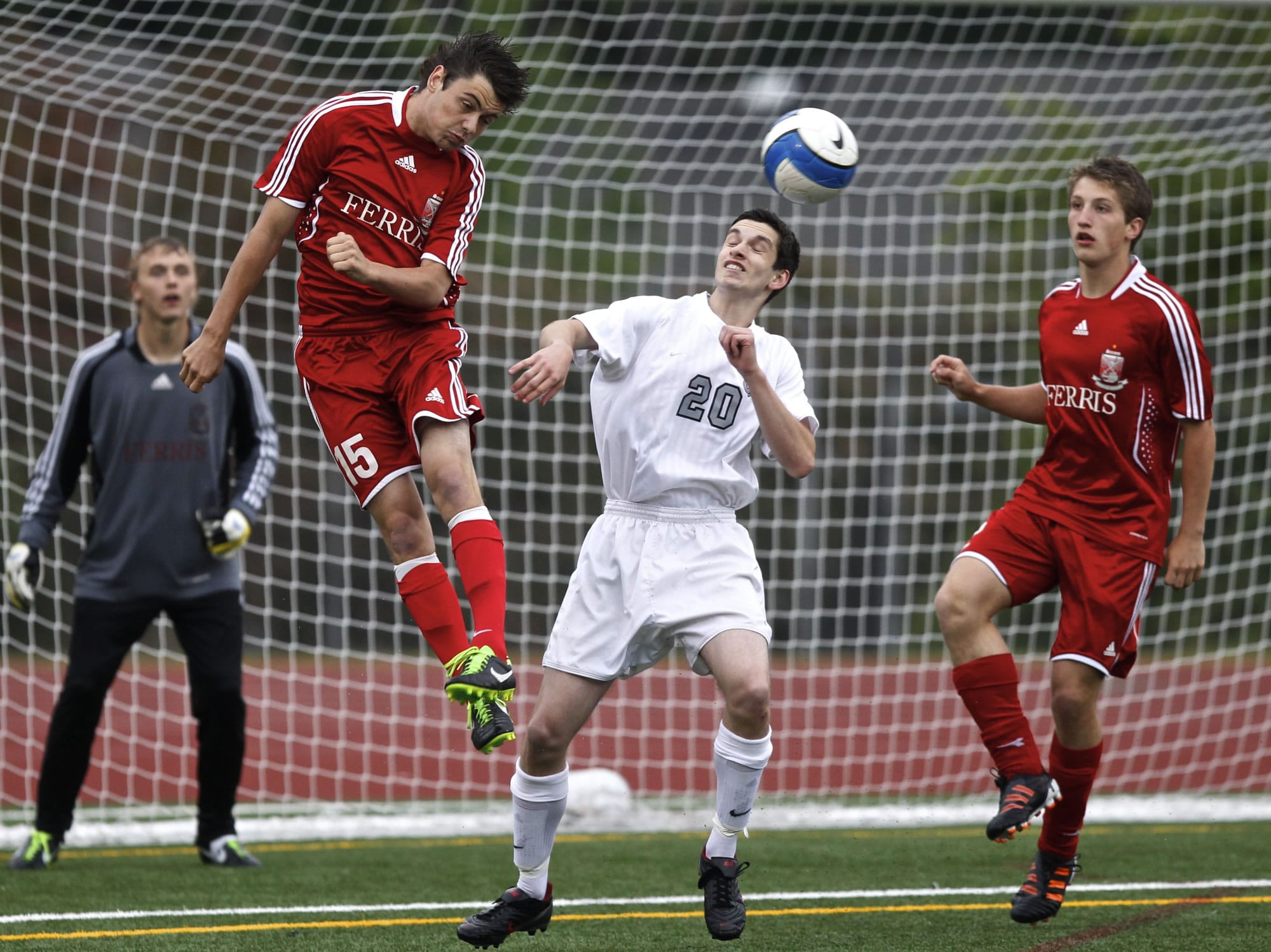 Union defender Luke Foster (20) plays ball in front of Ferris goal during state soccer quarterfinal game Saturday.
