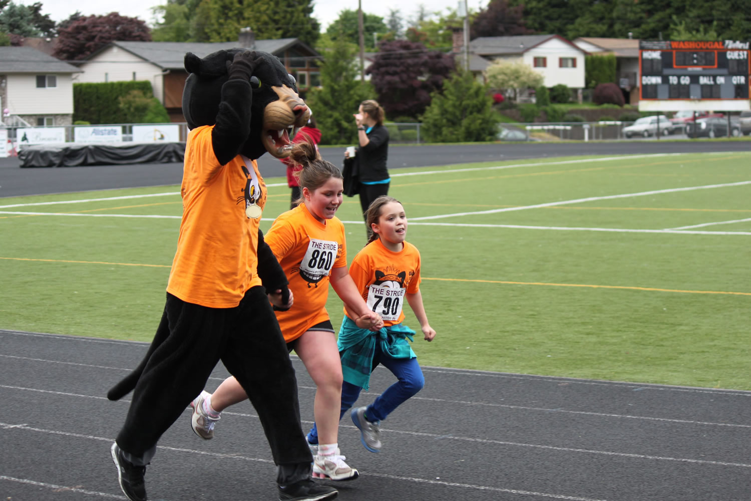 The Washougal High School Panther mascot encourages youngsters as they cross the finish line during Saturday's 10th annual Student Stride for Education at Fishback Stadium.