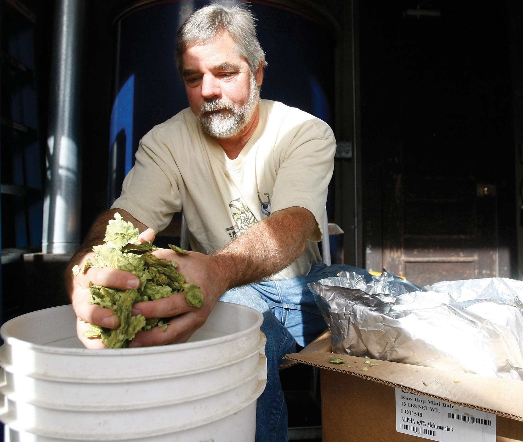 Roseburg Station Pub and Brewery head brewer Tom Johnson measures out hops at the brewery in Roseburg, Ore.