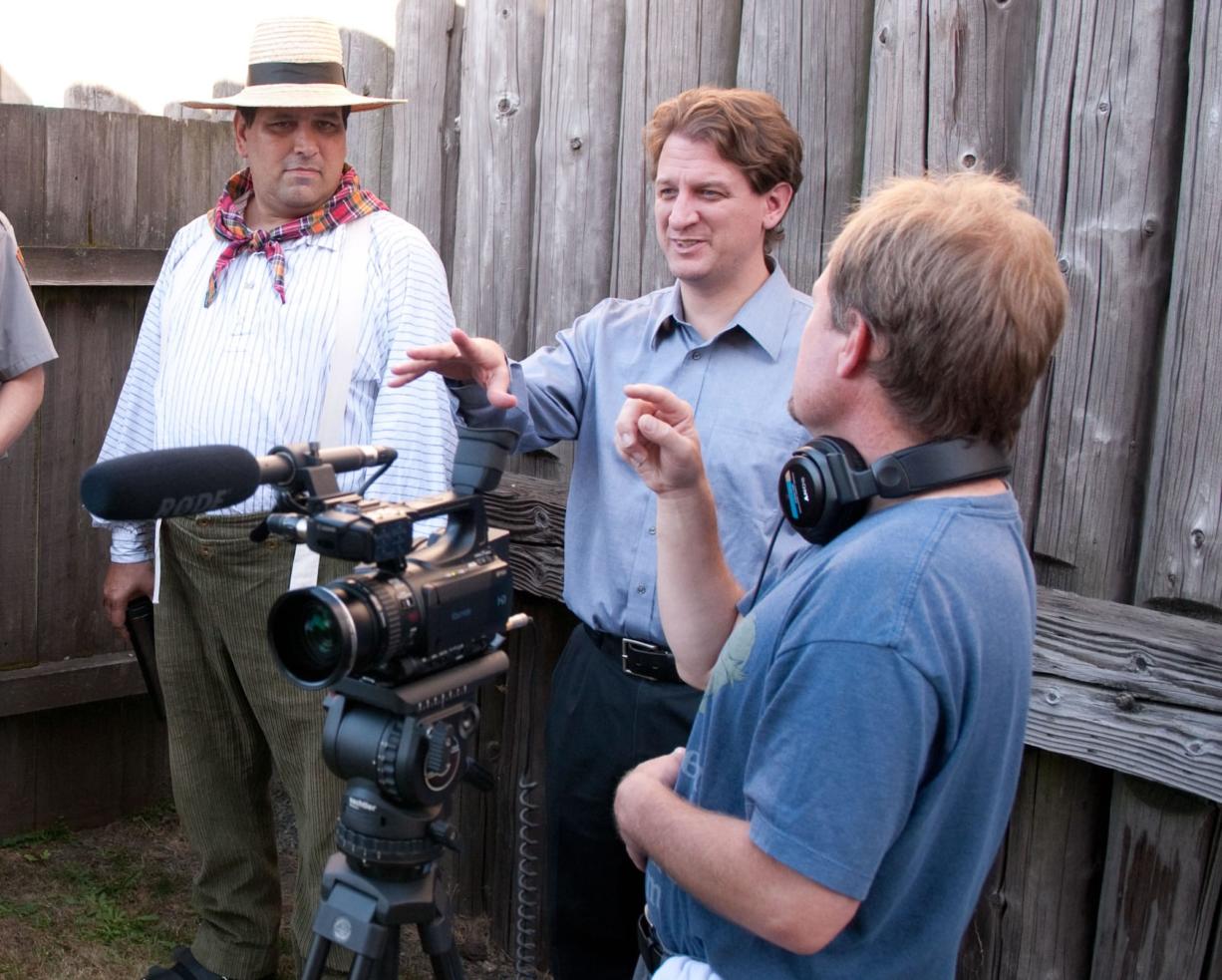 Brett Oppegaard, center, sets up a scene during production of a &quot;Kanaka Village&quot; video segment for the mobile storytelling app at Fort Vancouver National Historic Site.