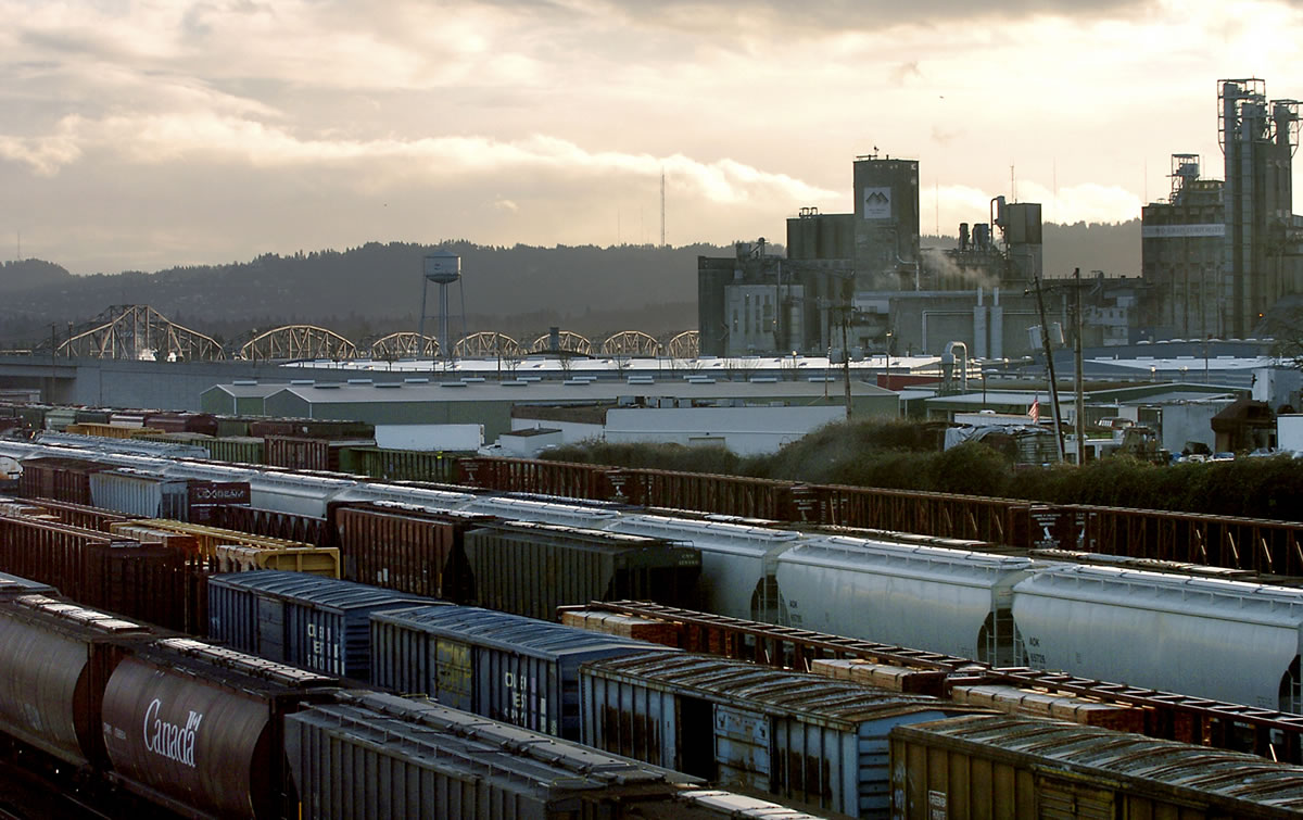 A view of the BNSF railyard below Fourth Plain Boulevard in west Vancouver looking south towards grain elevators at the Port of Vancouver.