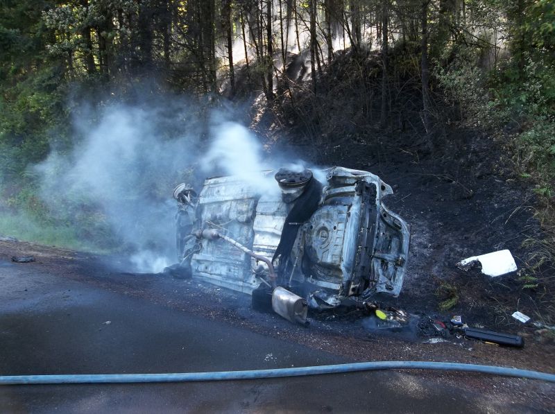 A 2010 Toyota Camry smolders at the side of Interstate 84 eastbound near Cascade Locks on Monday.