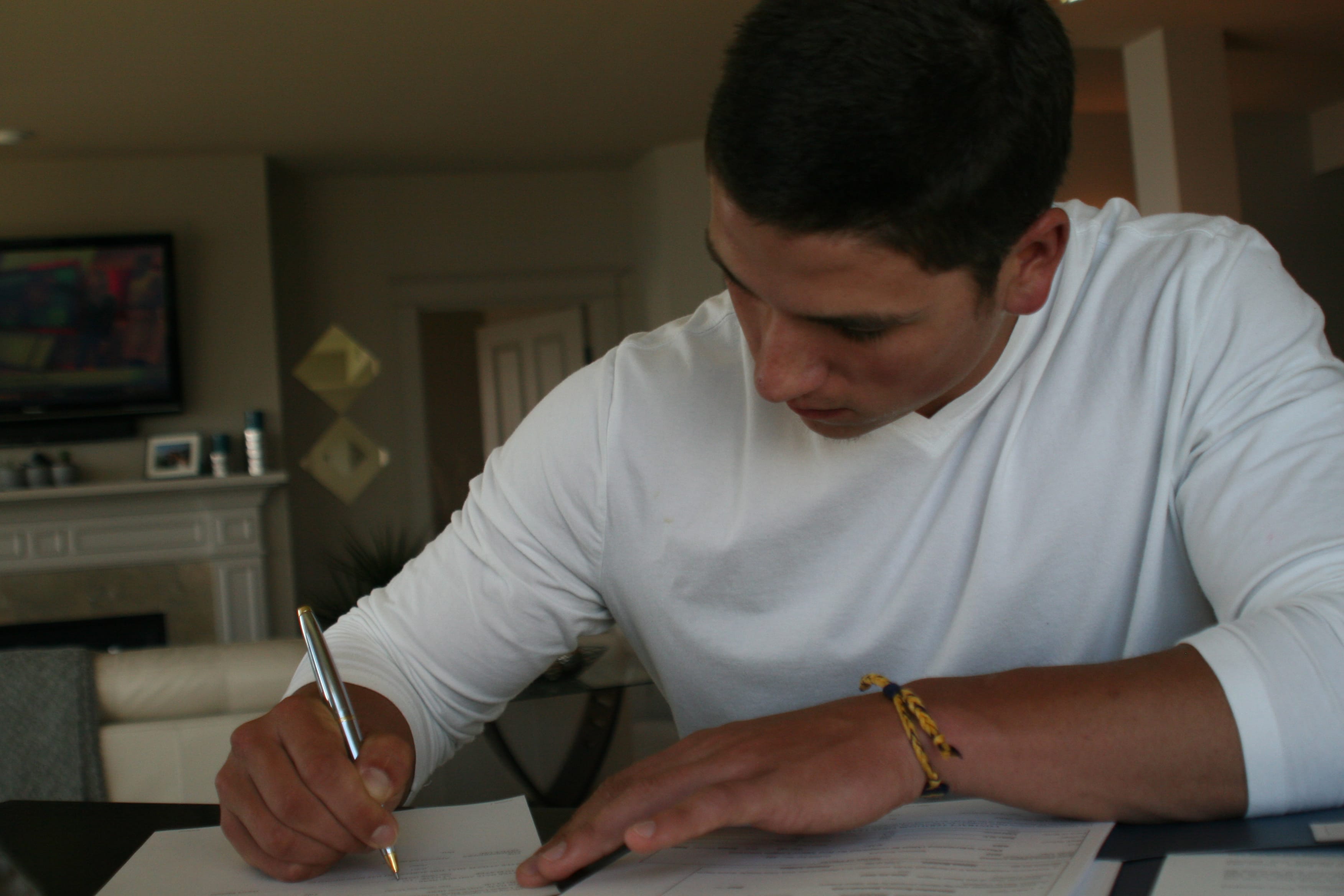 Camas pitcher Taylor Williams puts pen to paper on a $400,000 Major League Baseball contract with the Milwaukee Brewers Monday.