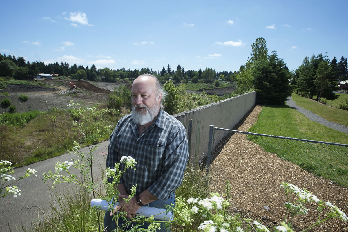 Stephen Wille, chairman of the Countryside Woods Neighborhood Association, stands last week at the boundary between First Place Neighborhood Park and the Evergreen Pit.