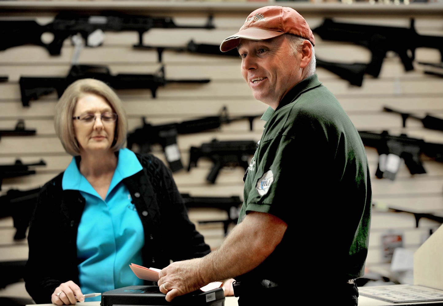 Mark Disque picks up a handgun he purchased from Becky Copley at Pasadena Pawn and Gun Store in Pasadena, Md., after waiting several weeks for approval on his background check.