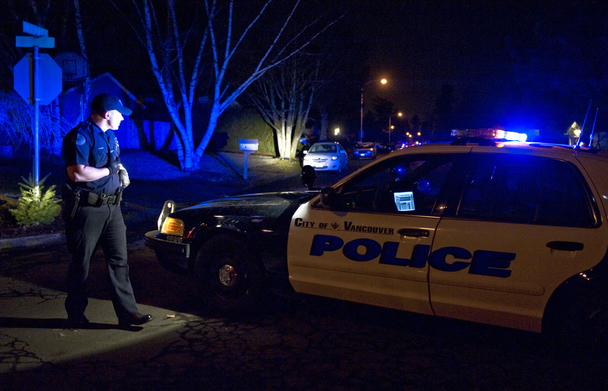 Vancouver Police Officer Brian Ruder secures a perimeter around the scene of a double homicide in the McLoughlin Heights neighborhood in February 2009.