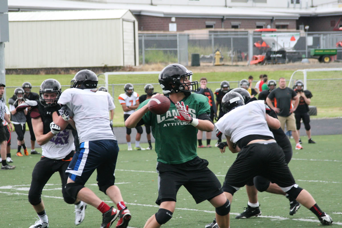 Camas quarterback Reilly Hennessey receives plenty of protection from his linemen during a scriammage game with Washougal June 12, at Cardon Field.