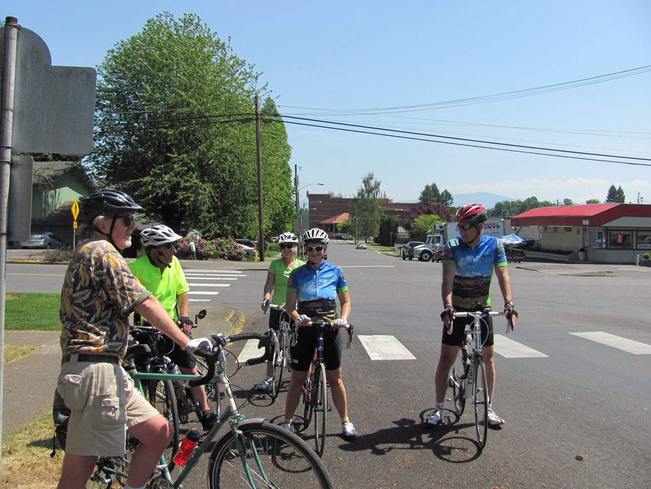Cyclists stop near a historical house, one of the points of interest during Joseph Blanco's history rides in Camas.