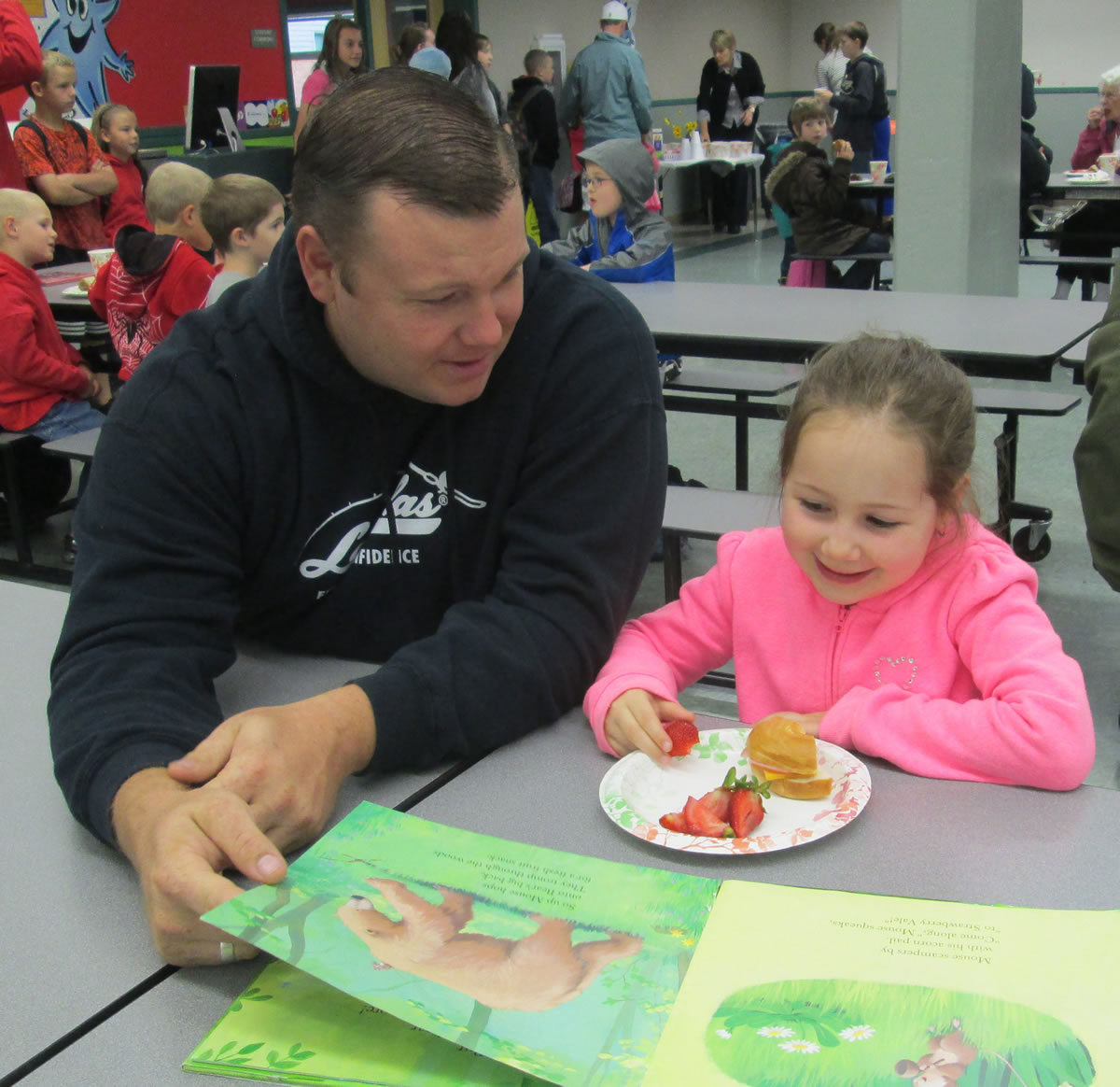 Seth Teeters and his daughter, Lela, enjoy the Books and Breakfast event at Cape Horn-Skye Elementary.