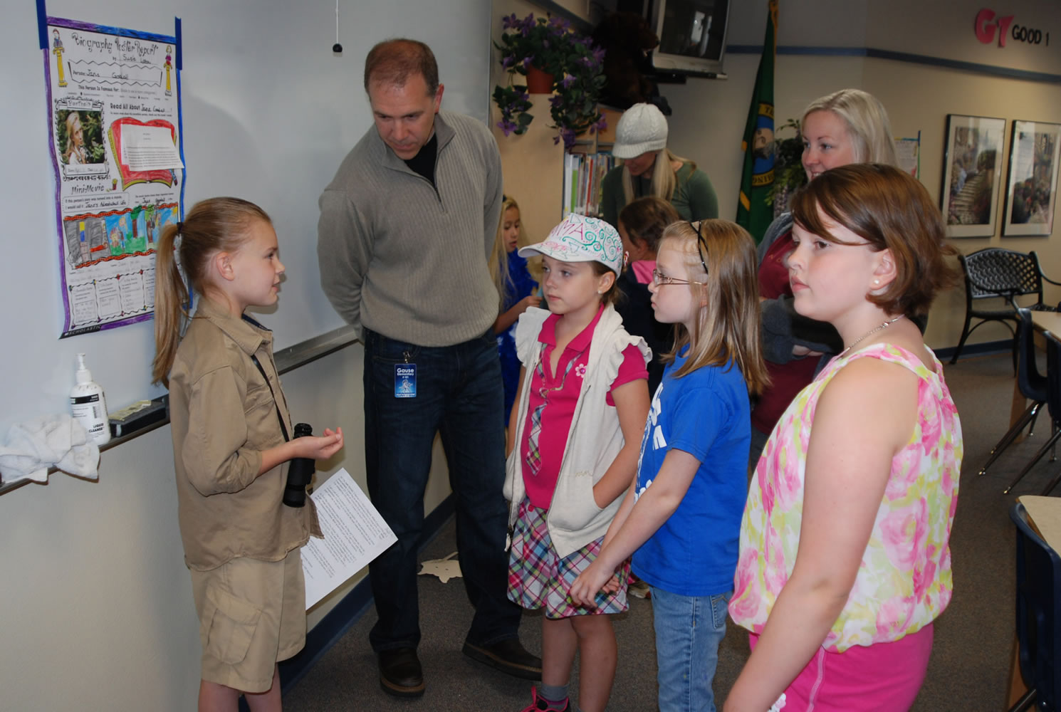 Gause Elementary second-grader Susie Liston shares information she has learned about Jane Goodall with Darren Taie and students (left to right) Emma Gorham, Caitlyn Bailey and Abigail McBride.