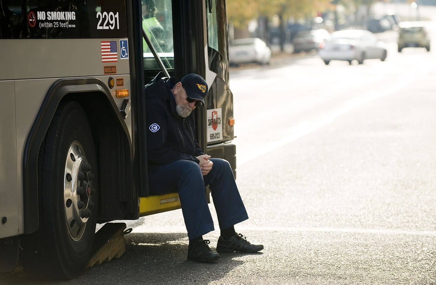 Bus driver Al Purvis sits at the scene of a Dec.