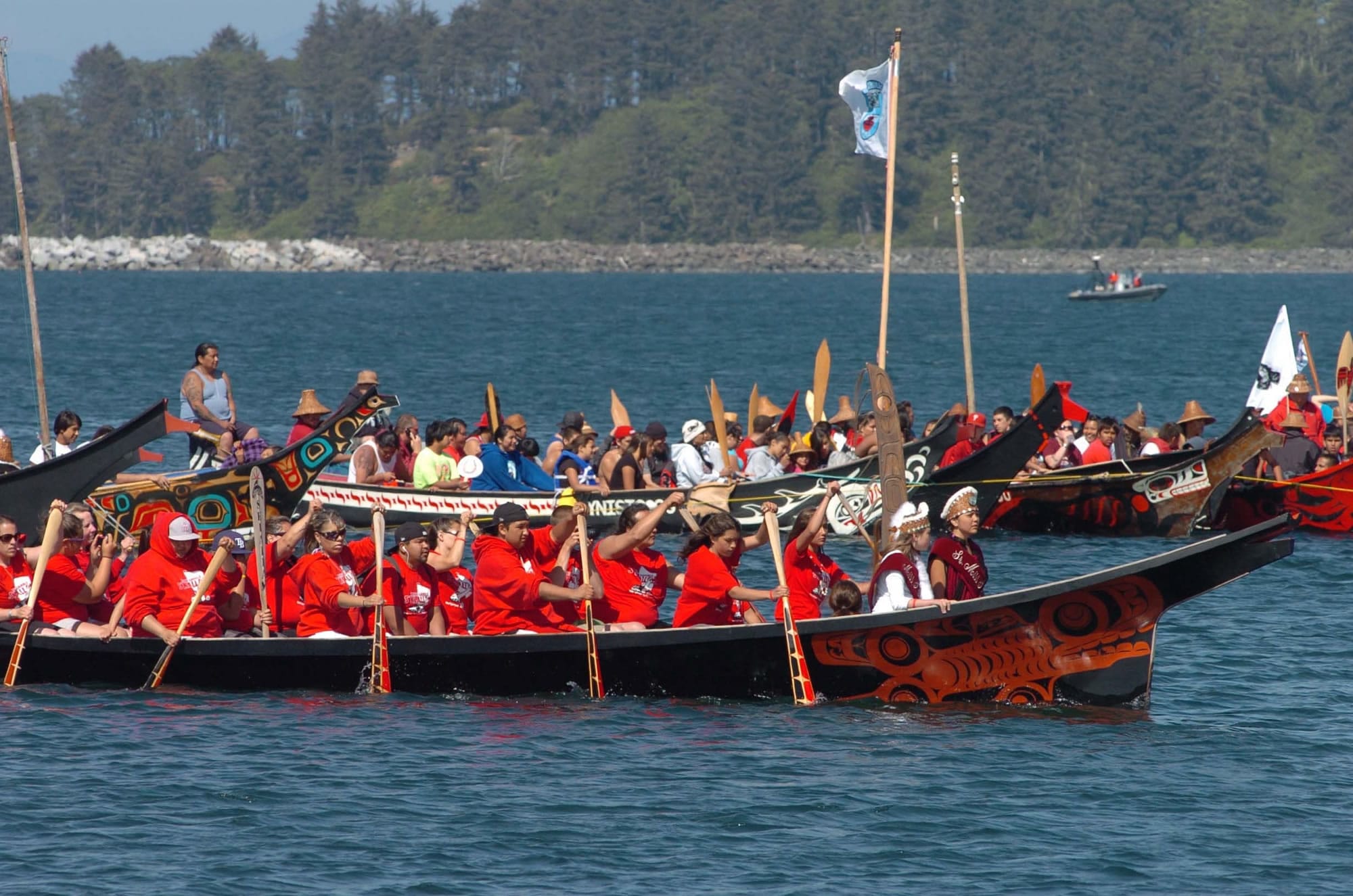 Pullers from the Port Gamble S'Klallam tribe, front, paddle their canoe toward a ceremonial landing Monday in Neah Bay. Eighty-six canoes from across the Pacific Northwest joined in the 2010 Tribal Canoe Journey.