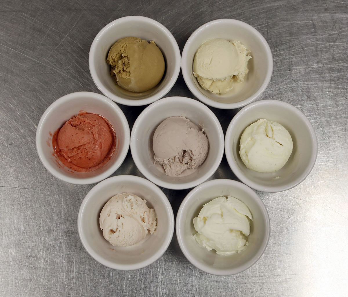 Seven of the homemade ice creams at the Thai Orchid Cafe in Lexington: Pictured are coffee stout, top left, bourbon-honey; middle row from left, organic strawberry sorbet, Kentucky blackberry and vanilla bean; bottom row from left, organic strawberry and coconut.