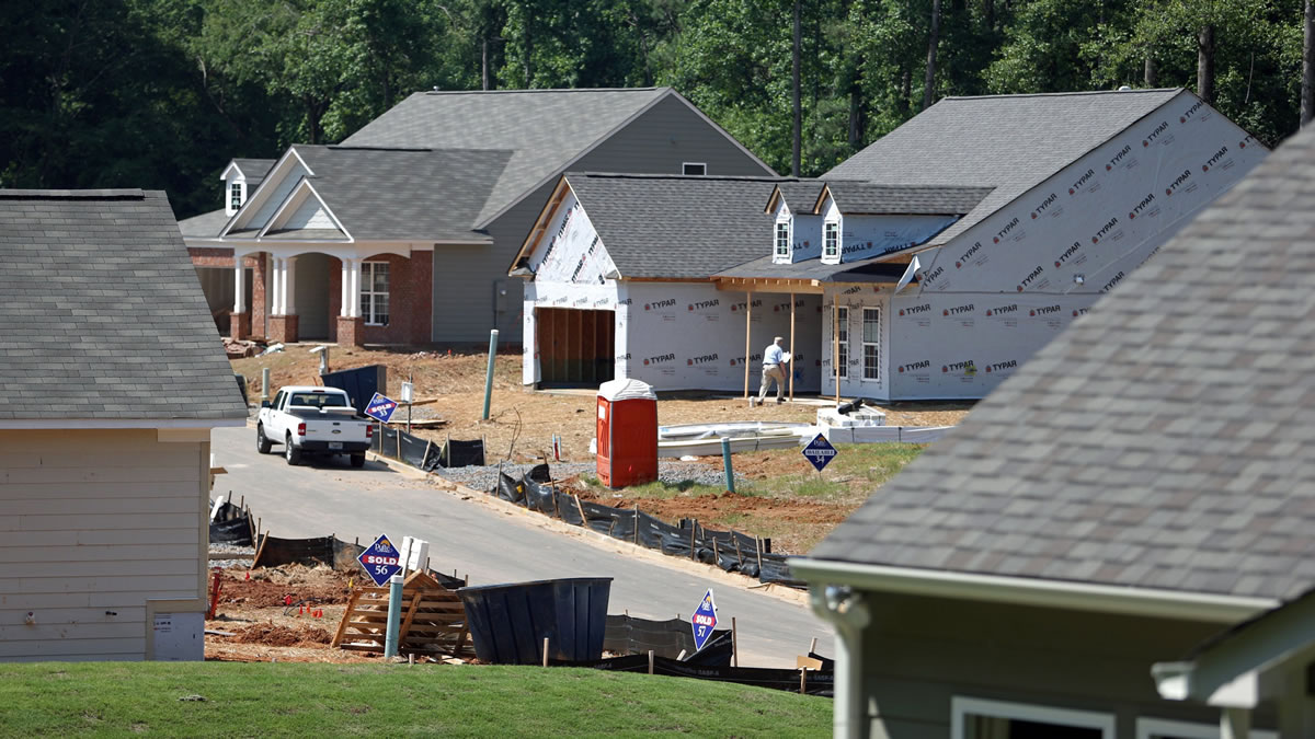Jason Getz/Atlanta Journal-Constitution
Pulte Group workers build homes in Marietta, Ga., in June. New home construction is on the rise, but higher-cost loans may put the brakes on the trend.