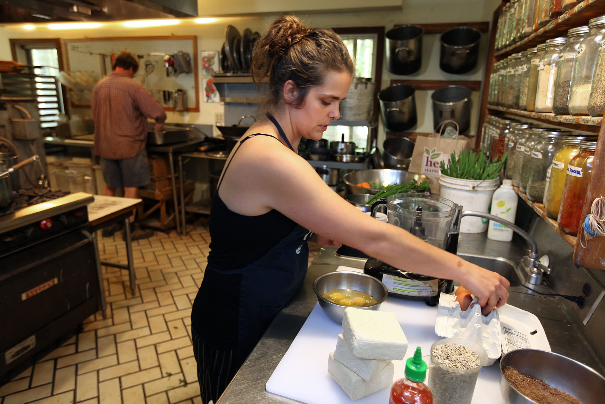 Carly Rodgers gathers ingredients for tofu burgers, on the dinner menu at Twin Oaks Community in Virginia.