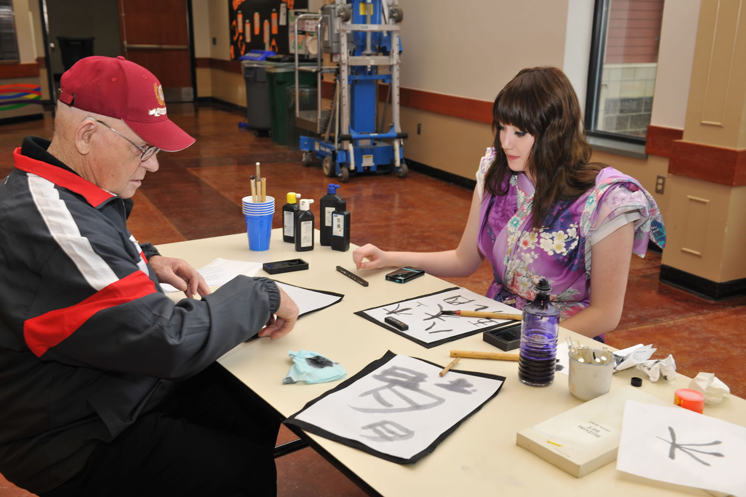 Wendell Heim created Japanese-style calligraphy with Noelle Schmidt, a sophomore at Washougal High School. Heim, a veteran of World War II and the Korean War, recently talked about his personal and military experiences with the Japanese class at WHS. &quot;I enjoyed having him in class discussions,&quot; Schmidt said.
