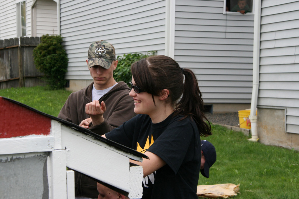 Marissa Stevens of Washougal and Payden Thornton of Ridgefield put shingles on a play house at Second Step housing.