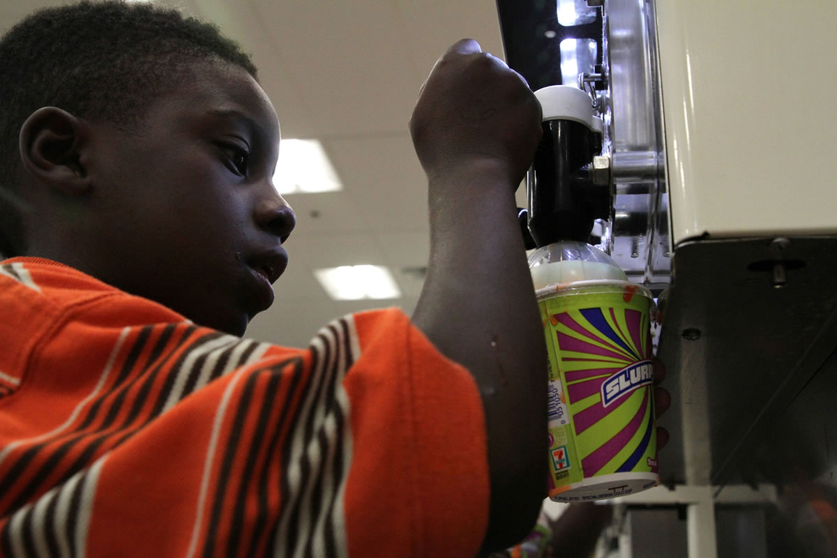Ray Jenkins, 6, makes a Slurpee at a 7-Eleven in Baltimore, Md.