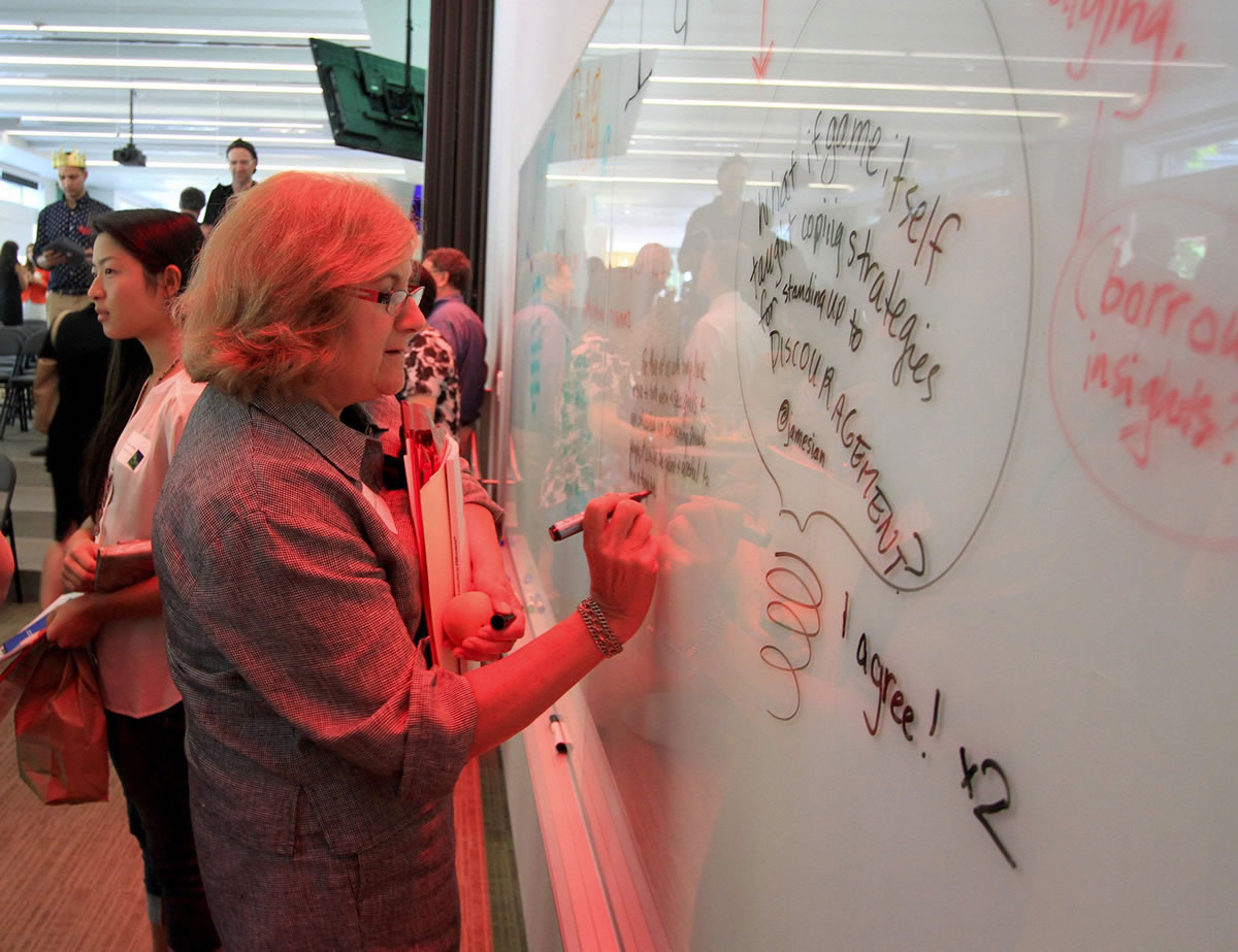 Rosemarie Ives, former mayor of Redmond, contributes an idea to the &quot;idea board&quot; at Northeastern University's offices in Seattle.